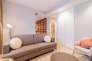 Family Apartment | Living area | 60-inch Smart TV with cable channels - Home Art Apartments Bernabéu (Madrid)