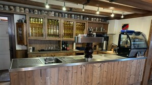 A bar area with a wooden counter, stainless steel sink, and a coffee machine. - Gasthof Zum schwarzen Roß (Zeitlofs)