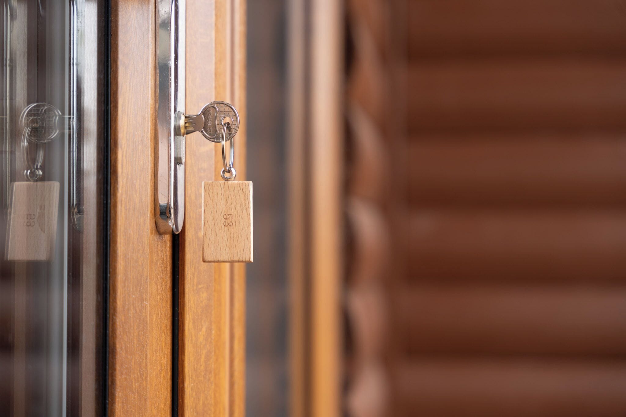 A wooden door with a metal handle and a padlock.