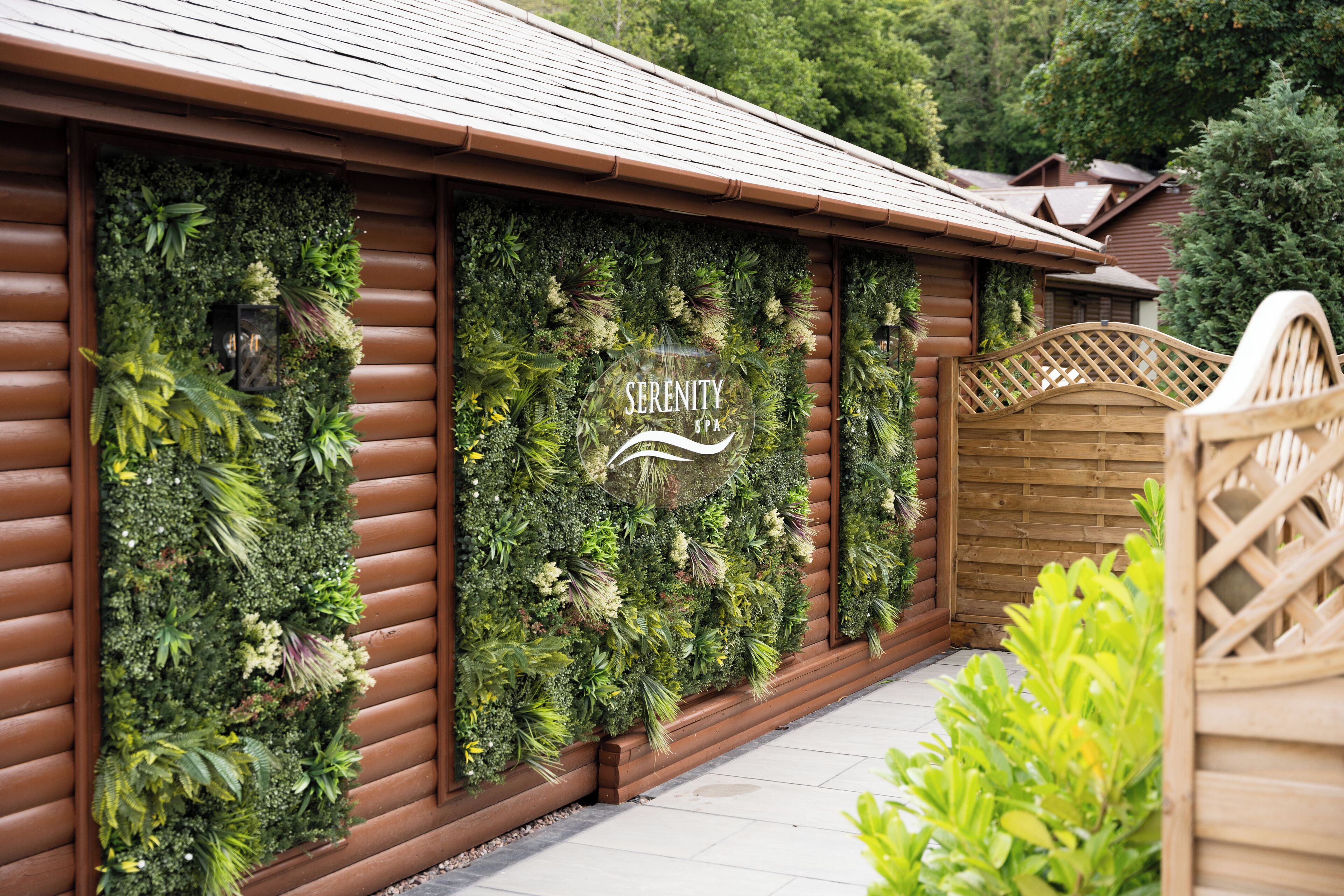 A log cabin with a wooden exterior and a vertical garden facade.