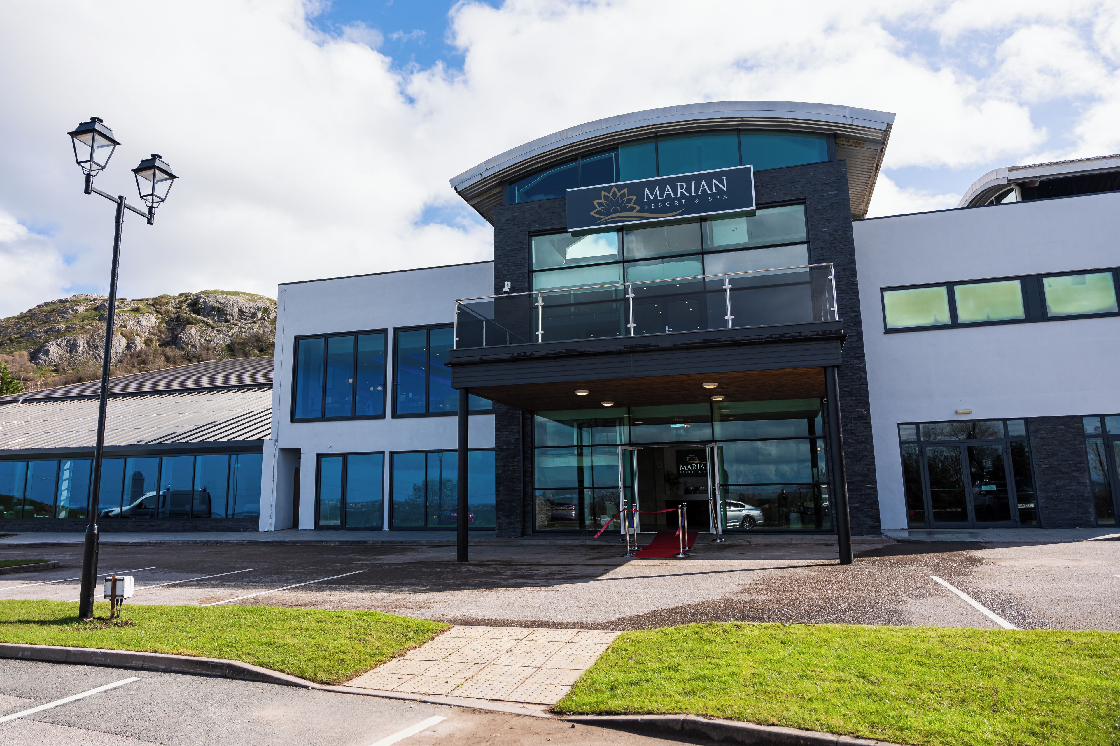 A modern building with a curved roof and a sign that reads 'MARIAN RESORT & SPA'.