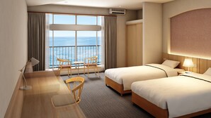 A hotel room with two beds, a desk with a chair, a view of the sea, and a balcony with a railing. - SADO Futatsugame View Hotel (Sado)