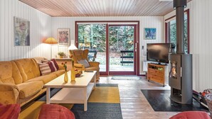 A cozy living room with a sofa, coffee table, and a fireplace.