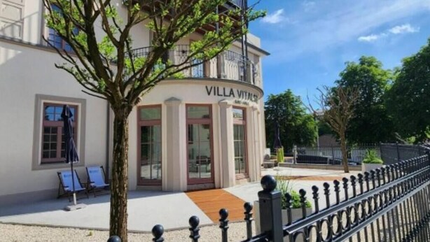 A building named "Villa Vitali" with a modern facade, large windows, and a paved entrance area. - Villa with balcony in the city center, elevator, luxury apartment on the Beletage (Bad Hall)