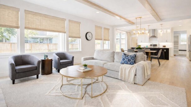 A spacious living room with a sofa, armchairs, and a coffee table. There is a kitchen in the background with modern appliances and a dining area. - Spacious Montana home near Big Sky and BZN airport (Belgrade)