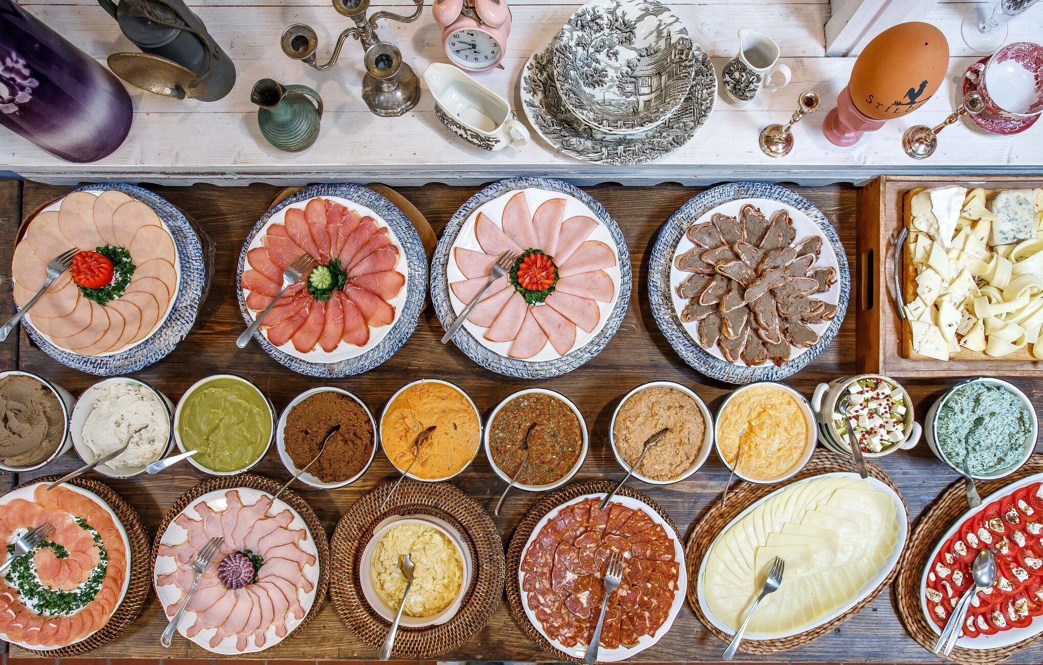 A variety of food items and utensils on a wooden table.