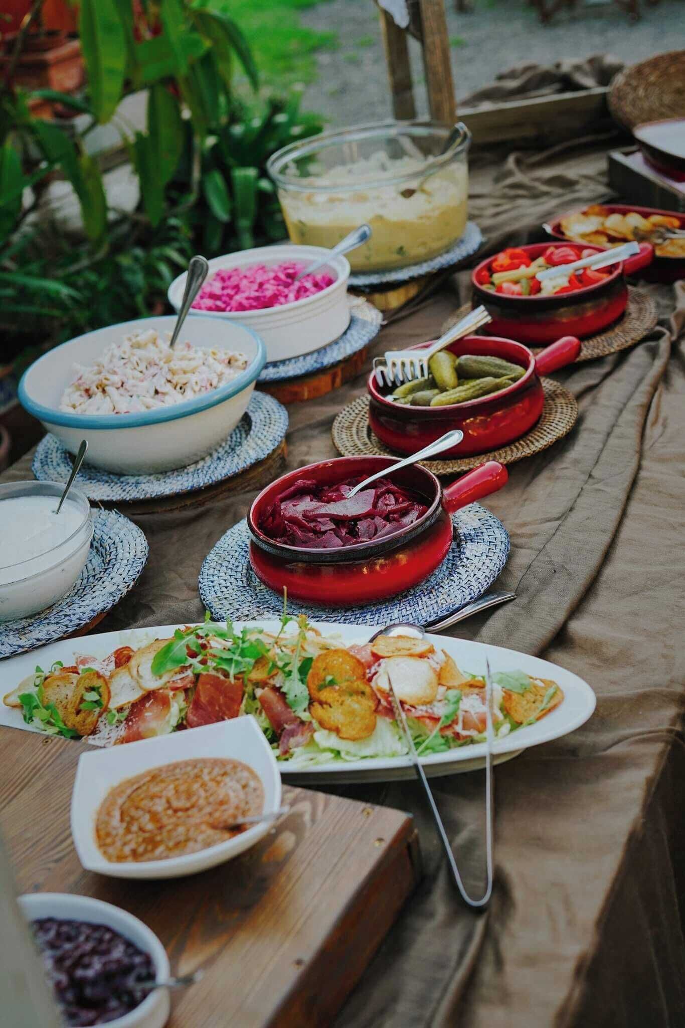 A table set with various dishes and condiments, suggesting a communal meal or buffet.