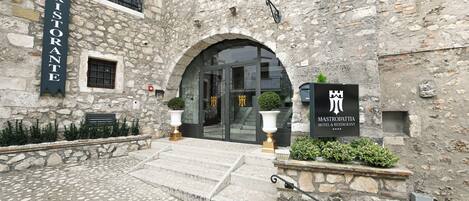 A stone building with a sign reading "Mastrodattia Hotel & Restaurant" and a "Ristorante" sign above the entrance.