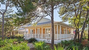 A two-story house with a porch, surrounded by trees and plants. - Seagrove’s 30A Window to Heaven: Pool and Beach (Santa Rosa Beach)