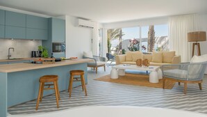 A modern living room with a central island, bar stools, a sofa, and a coffee table.