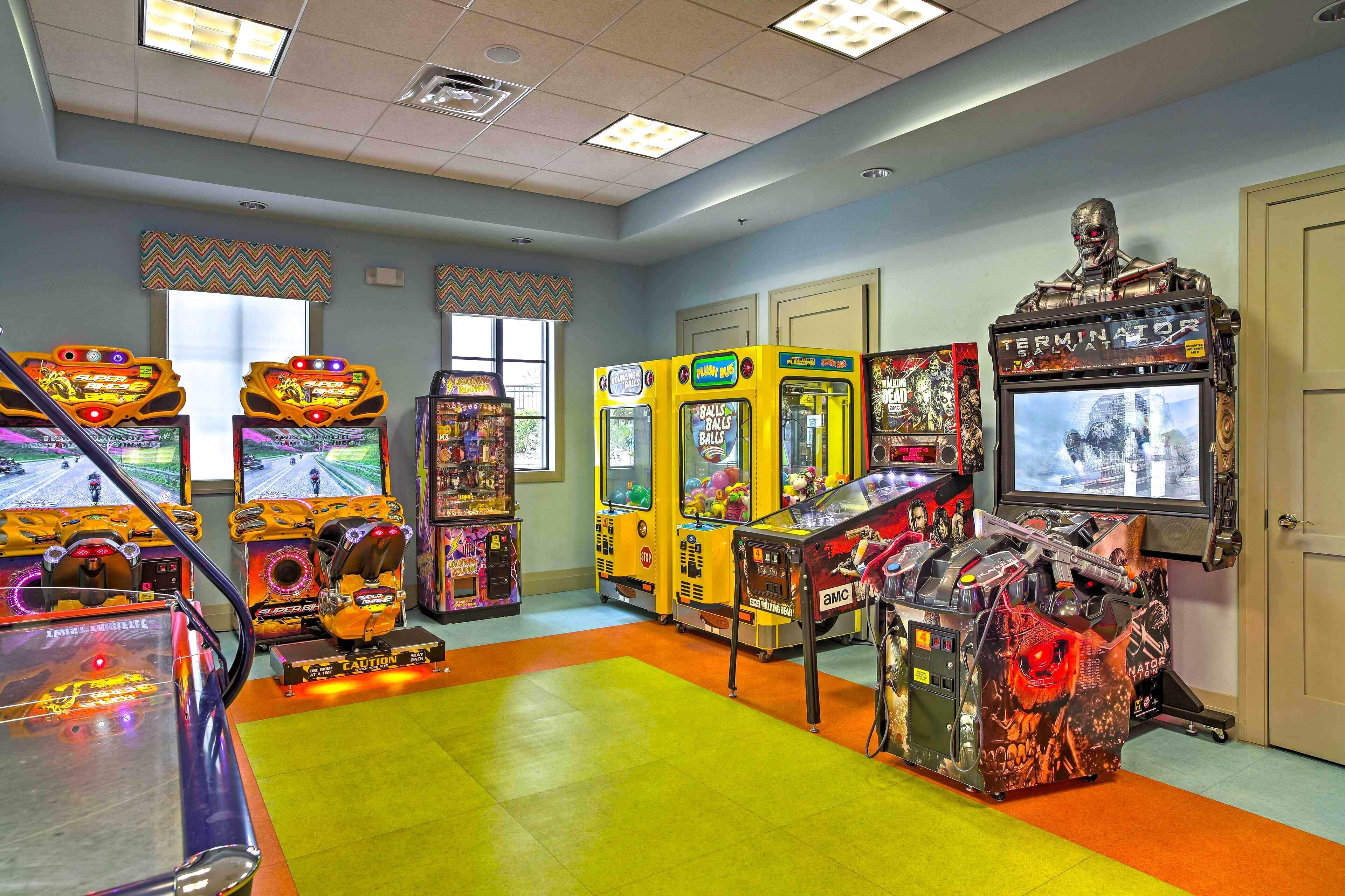 An arcade room with various gaming machines, including a large 'Terminator' themed machine.