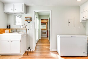 A kitchen with white cabinets, a wooden floor, and a refrigerator. - < 1 Mi to Boat Ramp: Lake Livingston Retreat! (Livingston)