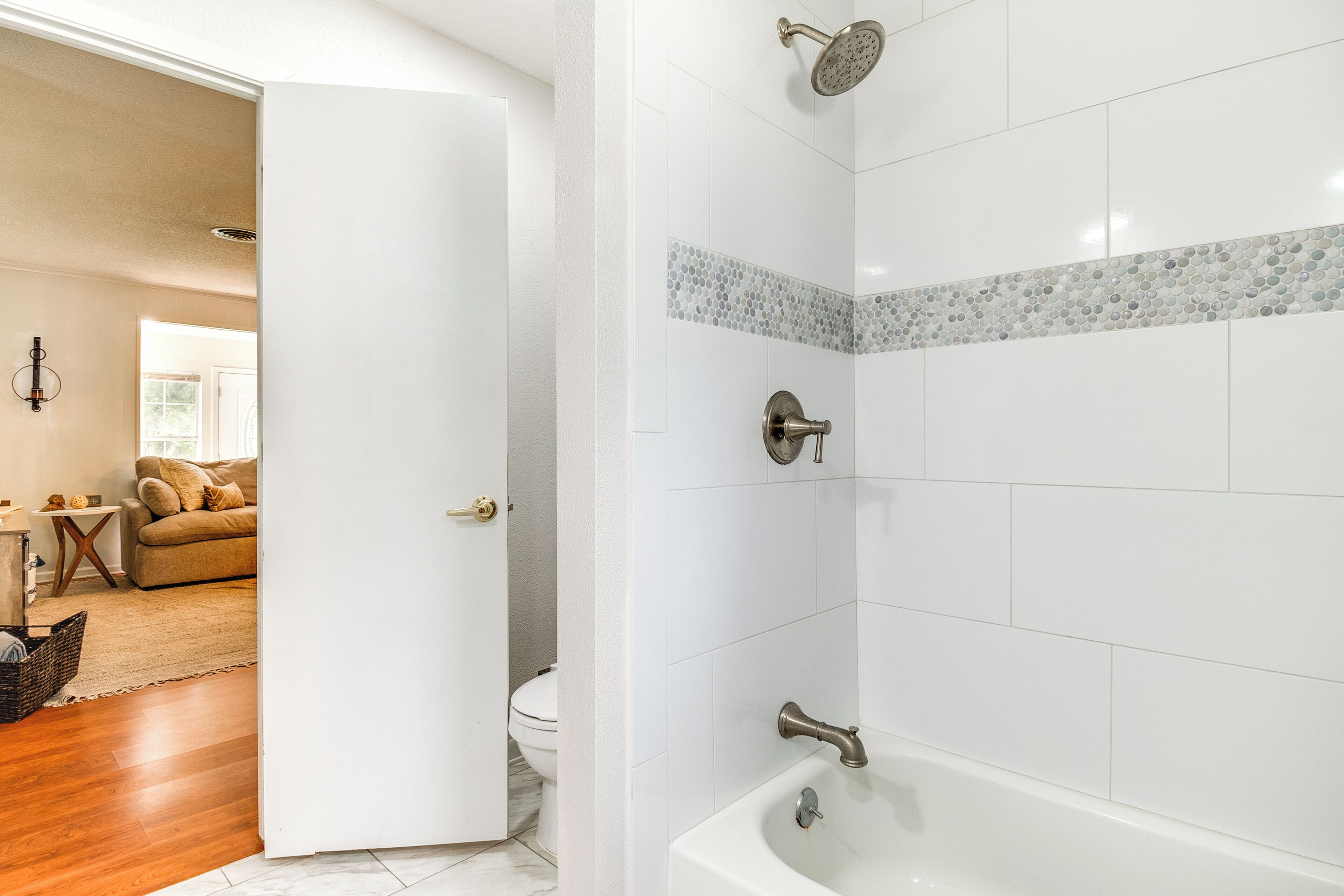 A bathroom with a bathtub, shower, and toilet.