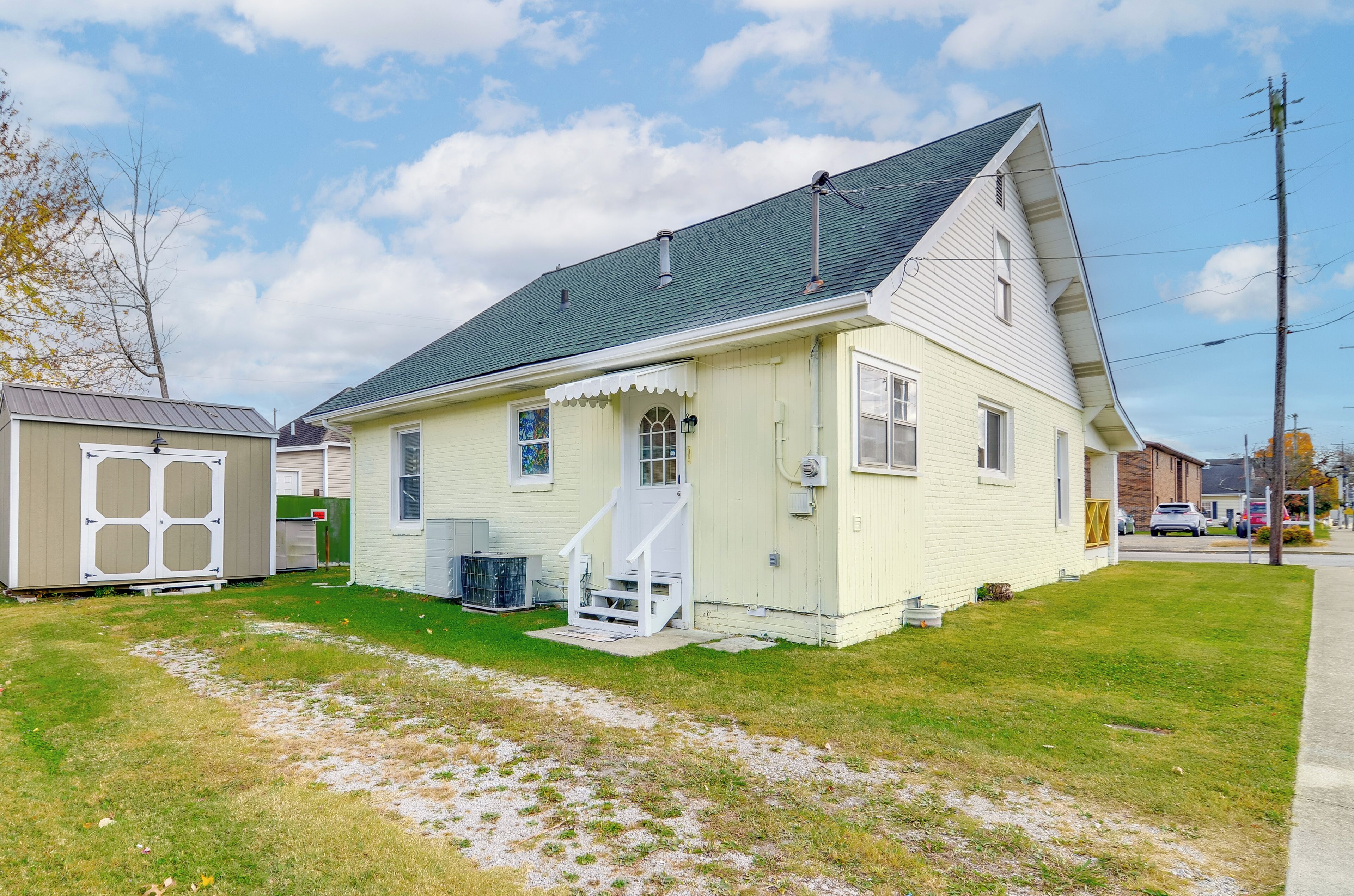 A single-story house with a front porch, a small attached garage, and a well-maintained lawn.