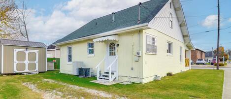 A single-story house with a front porch, a small attached garage, and a well-maintained lawn.