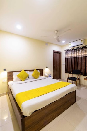 Relax in this inviting space with a large bed, desk, and comfortable chair.