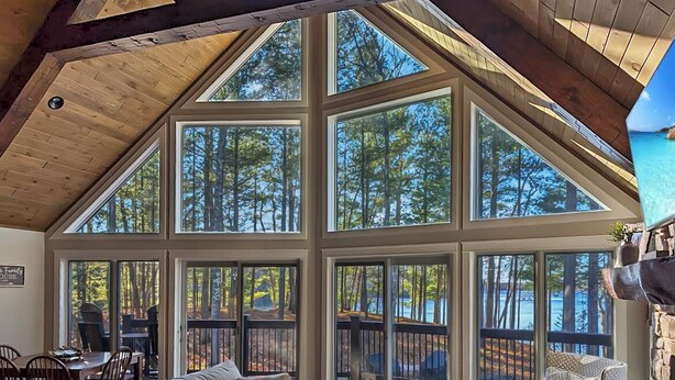 A spacious room with large windows, a wooden ceiling, and a cozy seating area. - Gorgeous Lakehouse, Sandy Bottom, Dock, AC (Lac du Flambeau)