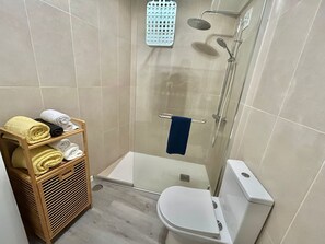 Shower, hair dryer, towels, toilet paper