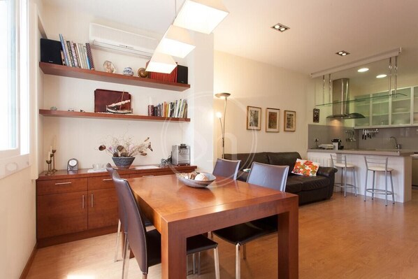Enjoy meals around the central dining table surrounded by comfortable chairs in this stylish living space.