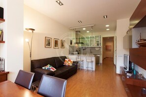Relax in this stylish living area with a comfortable sofa and dining table.