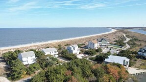A coastal property with multiple buildings, a beach, and a view of the ocean. - Bayfront in Broadkill Beach (Milton)