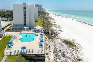 A hotel with a swimming pool, beach access, and a view of the ocean. - Beach House 401d 1 Bedroom Condo (Miramar Beach)