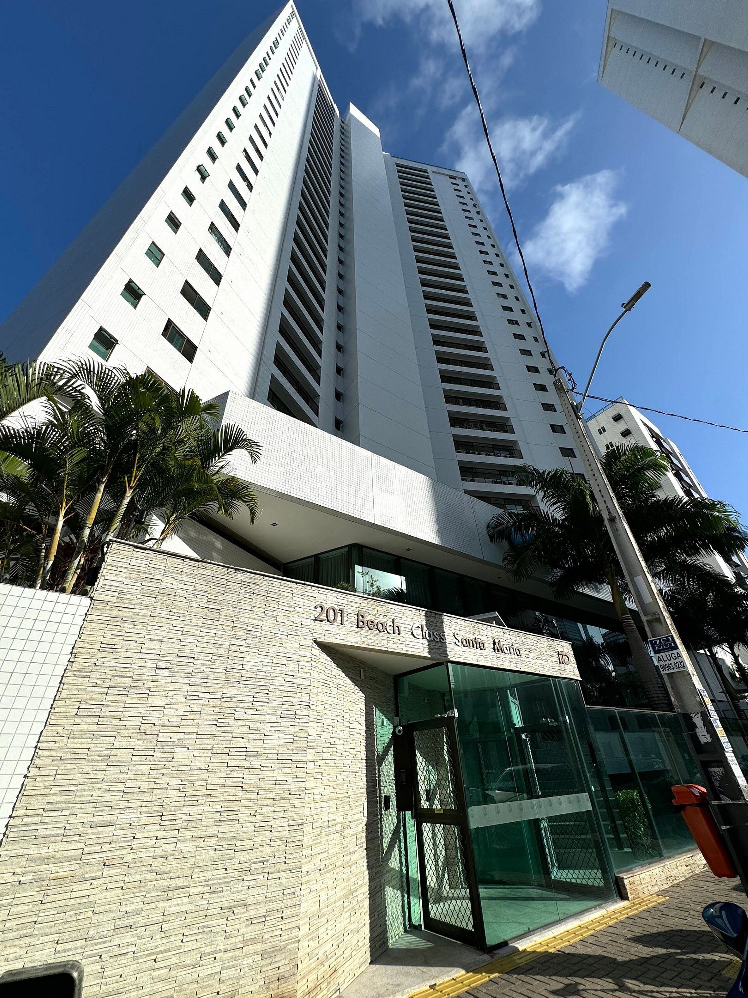 A tall, modern building with a prominent entrance labeled "201 Beach Close Santo Antonio."