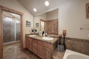 A bathroom with two sinks, wooden cabinets, a large mirror, and a shower enclosure. - Antler At Lakota 407 3 Bedroom Home (Winter Park)