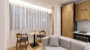 Standard Apartment 102, Kitchen | Living area | 50-cm Smart TV with digital channels