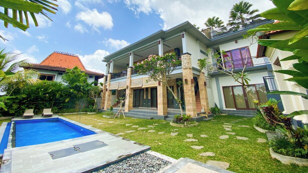A two-story house with a swimming pool, a garden with stepping stones, and a red-tiled roof. - Oemah Surya Ubud (Ubud)