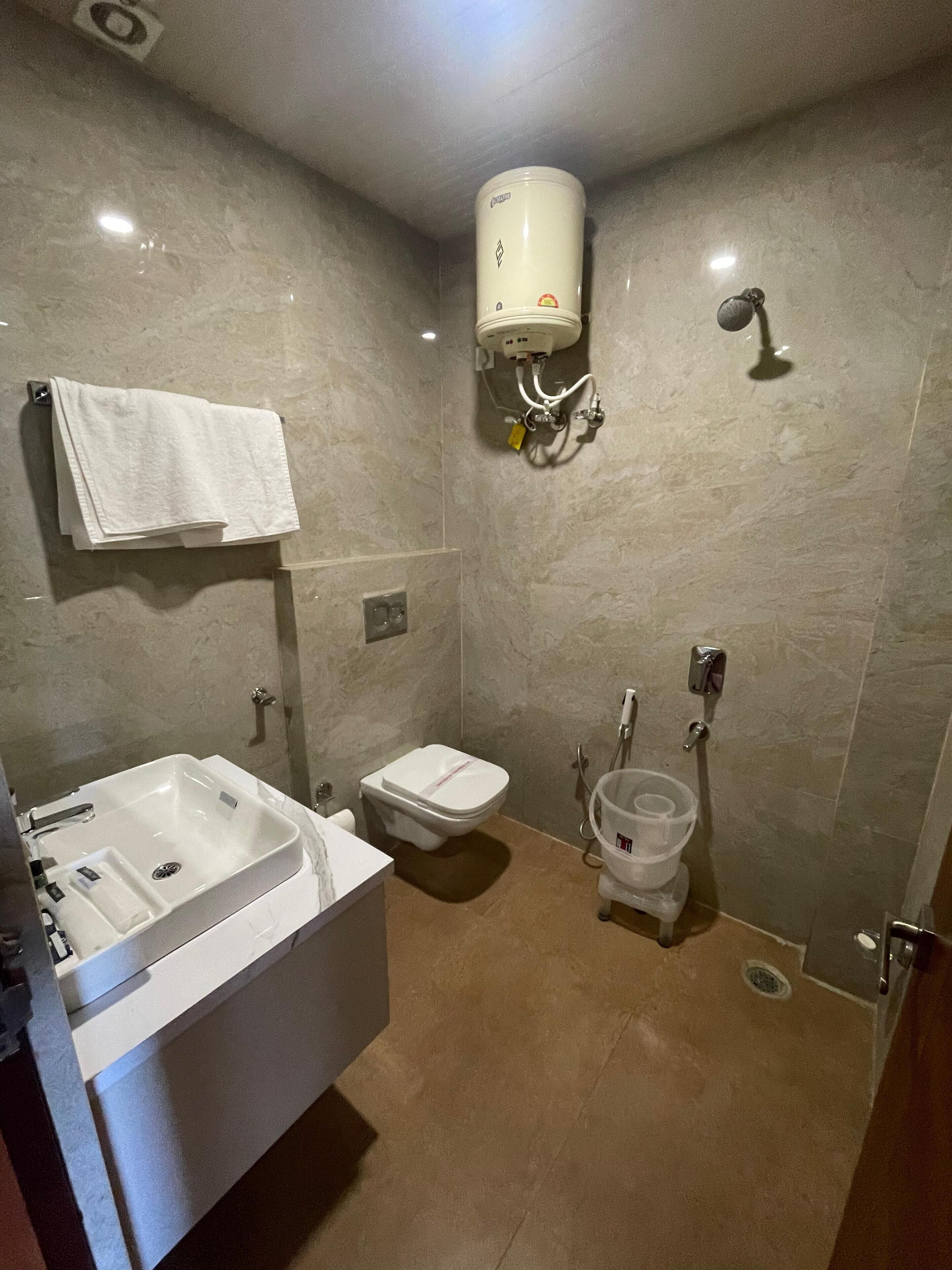 A bathroom with a sink, toilet, and shower.