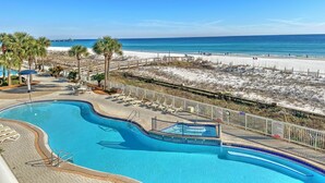 A resort pool with a view of the beach and ocean.