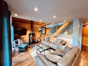 Una sala moderna con un conjunto de sofá, una mesa de centro y una chimenea.