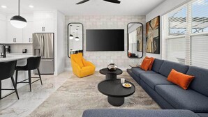 A modern living space with a kitchen, a dining area, and a seating area with a sofa and chairs. - Wendy's Wing | Gorge Villa w/ Pirate BR, Grand Suites & PVT Pool - Near Airport (Orlando)