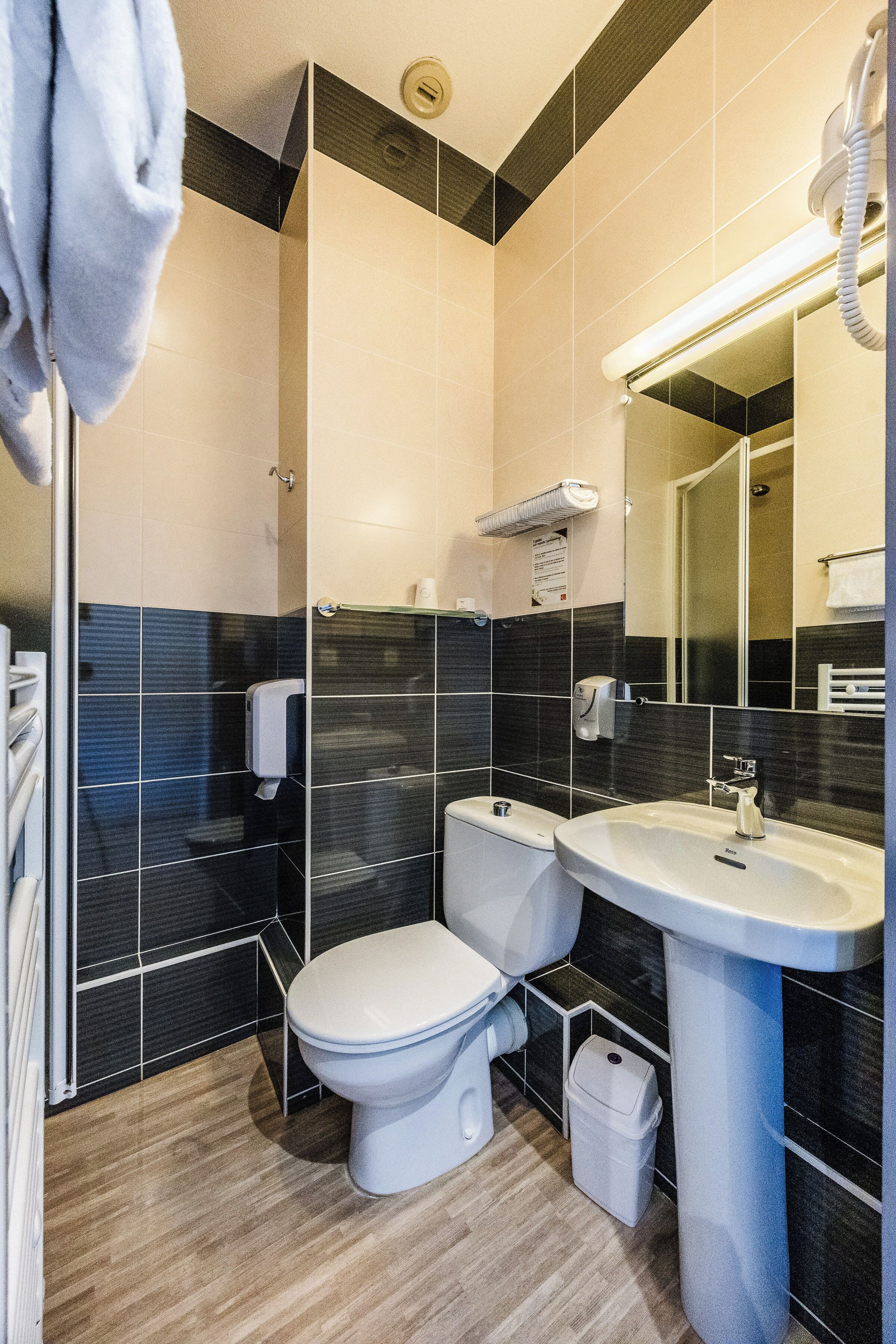 Ein modernes Badezimmer mit Toilette, Waschbecken und Dusche.