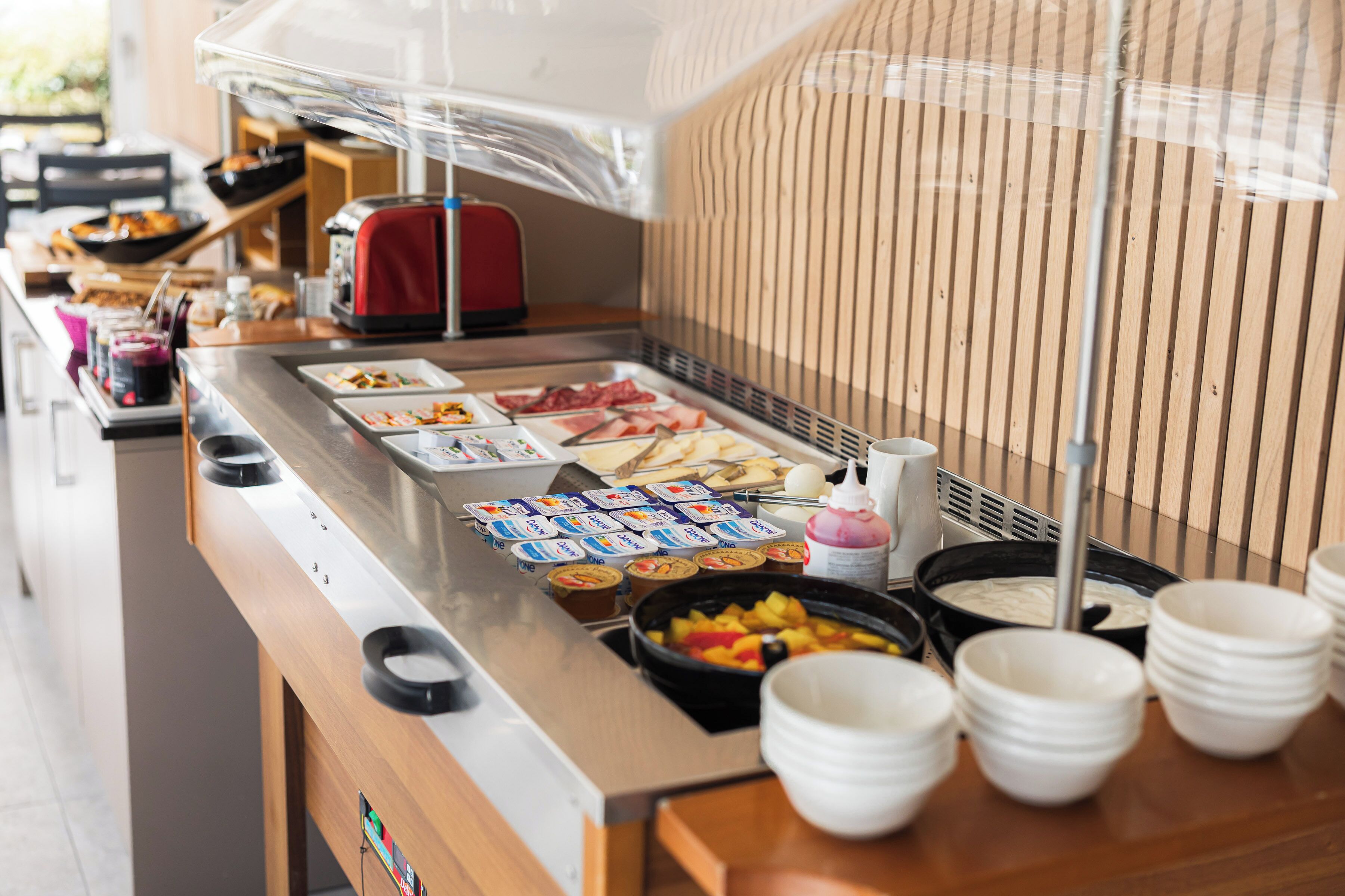 A buffet with various food items and condiments.