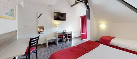 A bedroom with a bed, a desk, and a chair.