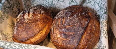Two loaves of bread in a cloth-lined basket.