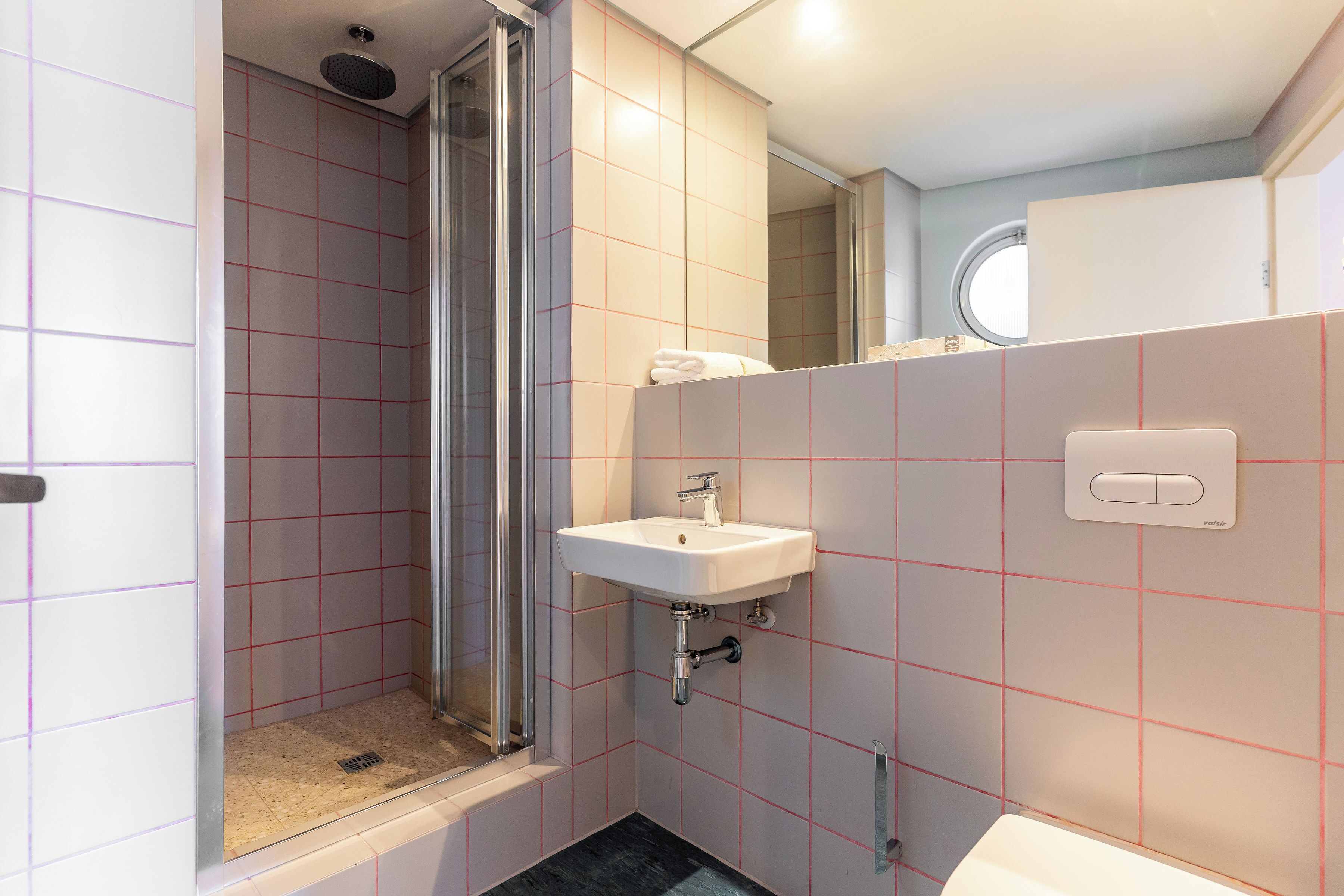 Un bagno con doccia, lavandino e WC.