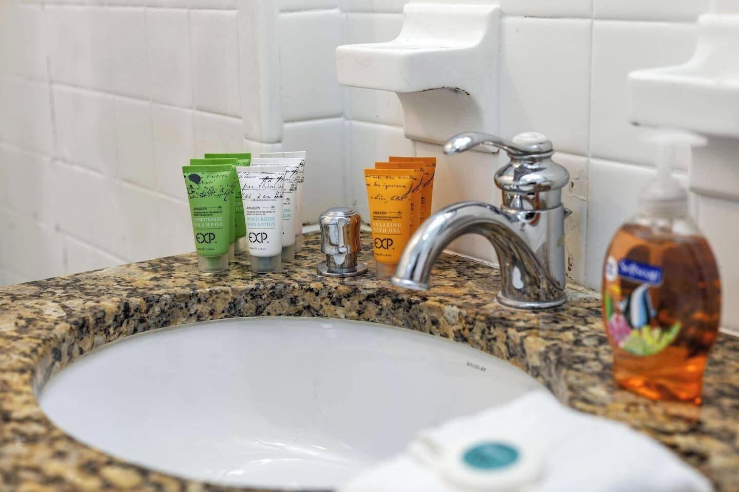 Et badeværelsesstel med toiletartikler, herunder shampoo, balsam og lotion.