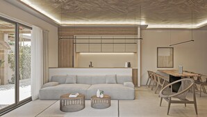 A modern living room with a sectional sofa, round coffee tables, a dining area with a wooden table and chairs, and a large window offering a view of the outdoors. - Cameo 3 Luxury Villa With Pool (Zakynthos)