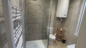 Shower, hair dryer, towels, toilet paper