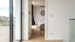 A modern bedroom with a large window, a bed, and a view of the outdoors. - Hazel Yellow Villa, Sintra, Lisbon (Sintra)