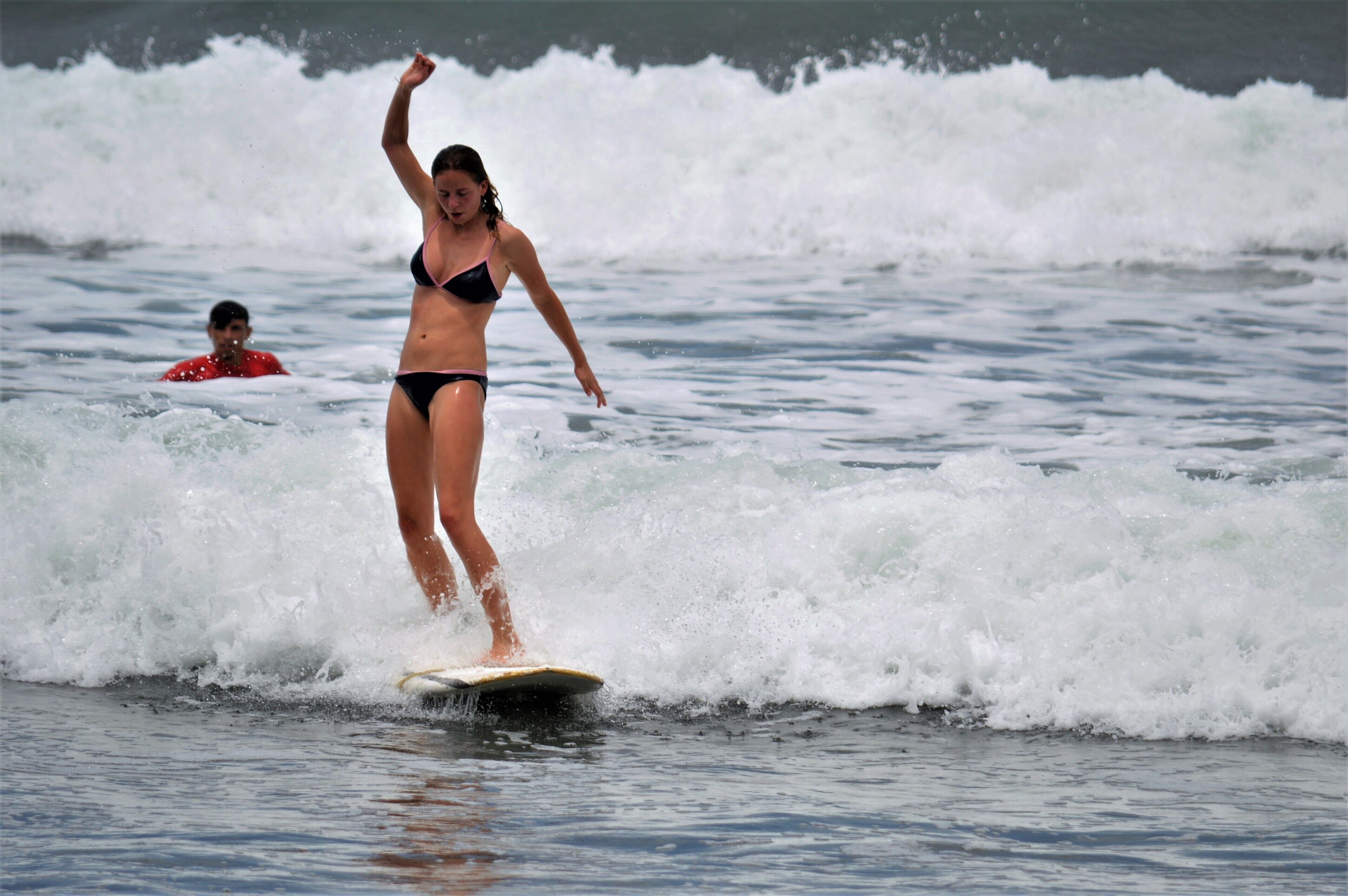 A person surfing on a wave in the ocean.