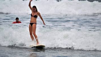A person surfing on a wave in the ocean.