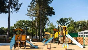 A playground with multiple slides and climbing structures.