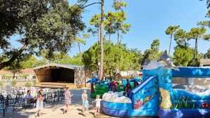 An outdoor area with a large inflatable slide and seating.