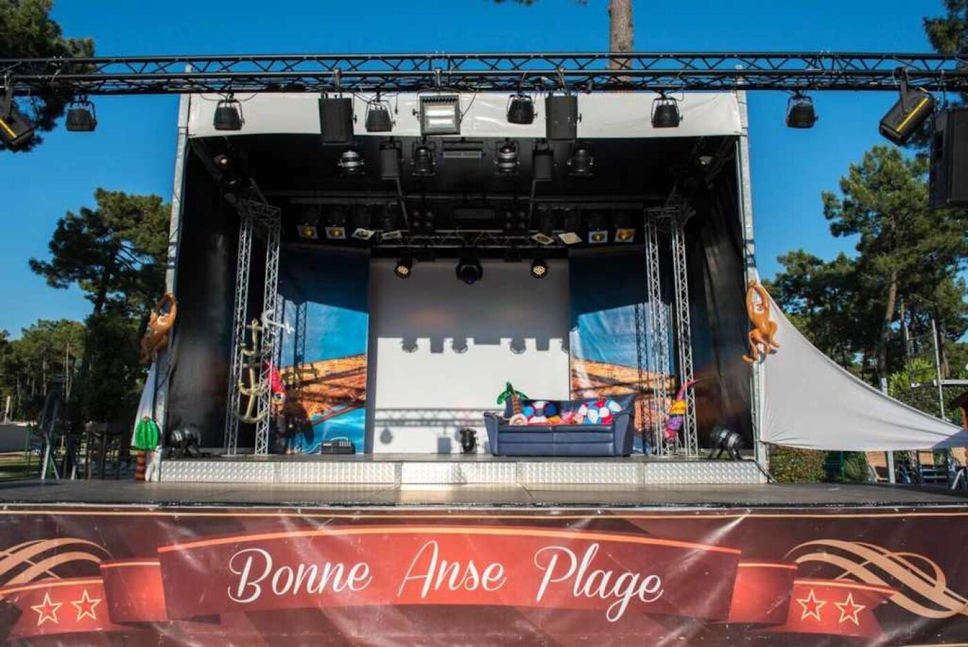 A stage with a banner reading "Bonne Anse Plage".