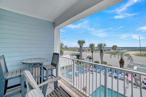 A balcony with a view of a pool and beach. - 🌊Across the Street from Beach | Gulf Views | Grand Caribbean 209🌊 (Orange Beach)