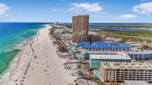 A coastal hotel with multiple buildings, a beach, and a clear view of the ocean. - 🌞Beachfront Condo with Indoor & Outdoor Pools | Harbour Place 109🌞 (Orange Beach)